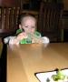 checking out the martini menu and enjoying his olive appetizer